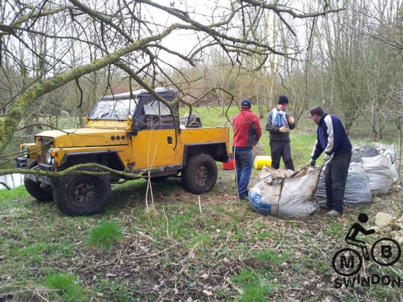 Moving limestone at a trail build day.