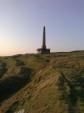 Obelisk at the top of a grassy hill