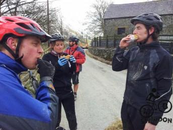 Stuffing face with food on a mountain bike ride.