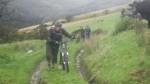 Pushing a bike up a steep hill.