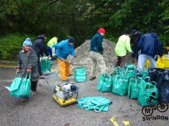 Shovelling gravel at a mountain bike trail.